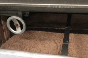 Olive paste inside a machine during the whipping process in a mill.